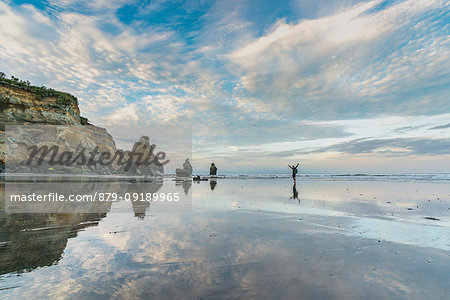 Man walking on the Three Sisters beach. Tongaporutu, New Plymouth district. Taranaki region, North Island, New Zealand.