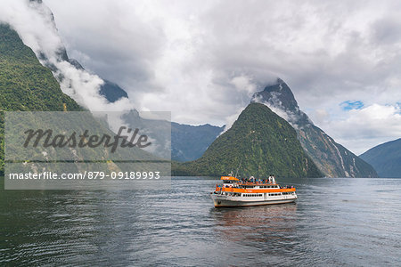 Touristic boat cruising in Milford Sound. Fiordland NP, Southland district, Southland region, South Island, New Zealand.
