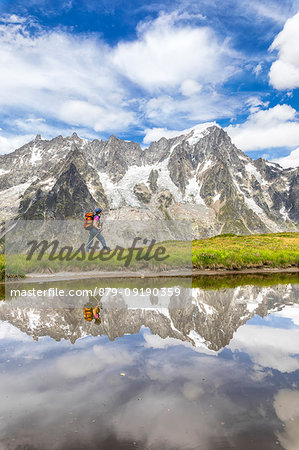 A trekker is walking on the Mont de la Saxe in front of Grandes Jorasses during the Mont Blanc hiking tours (Ferret Valley, Courmayeur, Aosta province, Aosta Valley, Italy, Europe) (MR) A trekker is walking on the Mont de la Saxe in front of Grandes Jorasses during the Mont Blanc hiking tours (Ferret Valley, Courmayeur, Aosta province, Aosta Valley, Italy, Europe) (MR)