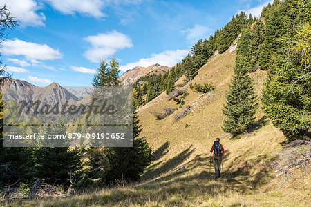 Mount Sasso Bianco, Dolomites, Alleghe, province of Belluno, Veneto, Italy, Europe. A hiker in the ascend to the summit of mount Sasso Bianco