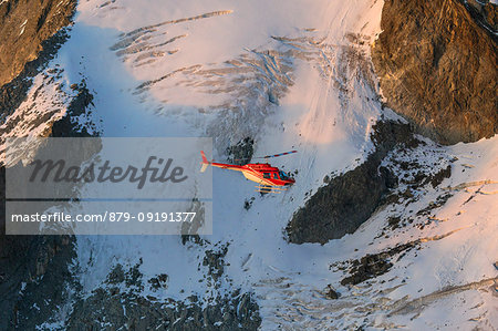 Helicopter in flight on glacier of Monte Disgrazia, Valmalenco, Val Masino, Valtellina, Lombardy, province of Sondrio, Italy Helicopter in flight on glacier of Monte Disgrazia, Valmalenco, Val Masino, Valtellina, Lombardy, province of Sondrio, Italy