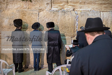 Ultra-orthodox Jewish men praying at the Western wall or Wailing wall the holiest place to Judaism in the old city of Jerusalem, Israel, Middle East