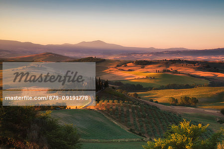 Podere Belvedere, San Quirico d'Orcia, Siena province, Tuscany, Italy. Sunrise over the farmhouse and the hills.