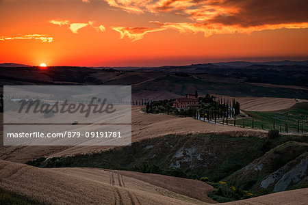 Red clouds at sunset over farm house in Tuscany, Asciano, Crete Senesi, Siena province, Tuscany, Italy Red clouds at sunset over farm house in Tuscany, Asciano, Crete Senesi, Siena province, Tuscany, Italy