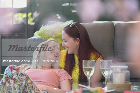Affectionate lesbian couple relaxing on patio