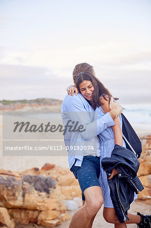 Affectionate couple hugging at beach