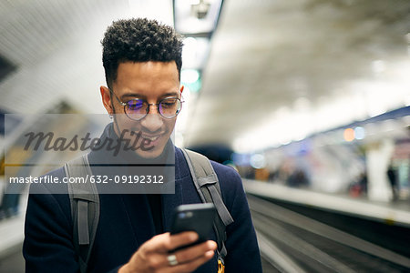 Smiling businessman using smartphone