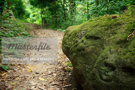 A carved petroglyph on a rock on the hiking trail to Pueblito in Tayrona National Park, Magdalena State, Colombia, South America