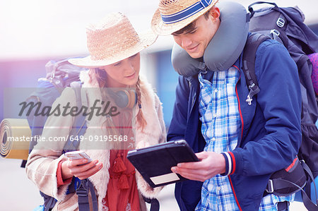 Backpacker couple using digital tablet