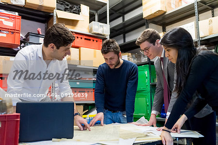 Colleagues in discussion in fencing prop workshop