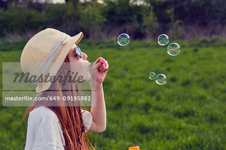 Girl playing with soap bubbles