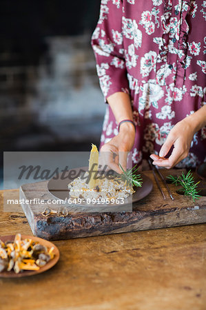 Mushroom risotto on plate being garnished