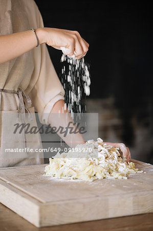 Woman mixing dough for gnocchi