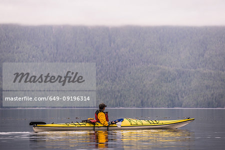 Man kayaking in lake, Johnstone Strait, Telegraph Cove, Canada