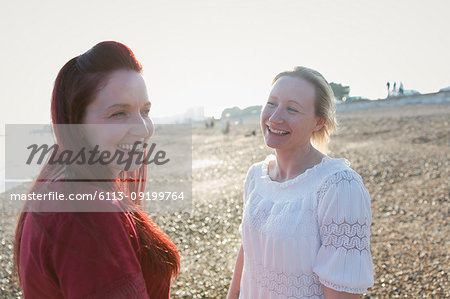 Happy lesbian couple on sunny beach