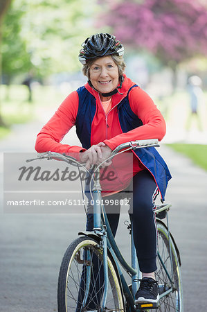 Portrait smiling, confident active senior woman riding bike in park