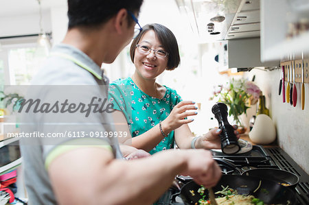 Couple cooking at kitchen stove