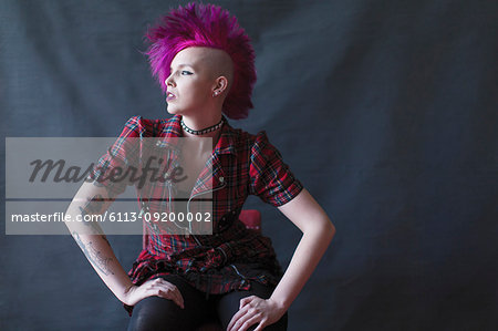 Portrait confident, cool young woman with pink mohawk