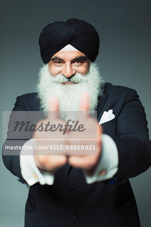 Portrait enthusiastic well-dressed senior man wearing turban, gesturing thumbs-up