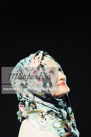 Portrait smiling, confident woman in floral hijab looking up