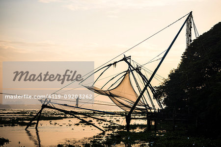 Traditional Chinese fishing nets at sunrise, Fort Kochi (Cochin), Kerala, India, Asia