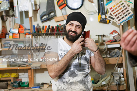 Carpenter talking on a cell phone in Sweden