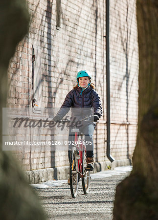 Mid adult woman riding a bicycle in Lahti, Finland