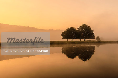 Reflections in River Derwent, dawn and autumn mist, Chatsworth Park, Peak District National Park, Chesterfield, Derbyshire, England, United Kingdom, Europe