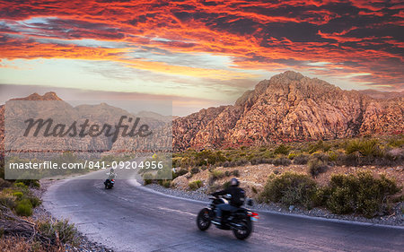 Motocycles driving through The Red Rock Canyon National Recreation Area at sunset, Las Vegas, Nevada, United States of America, North America