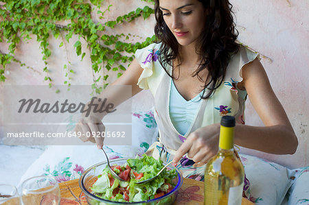 Woman mixing salad