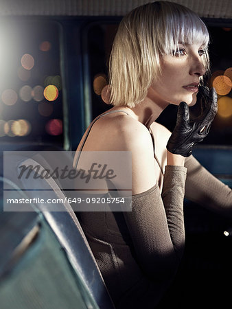 Woman wearing leather glove in car