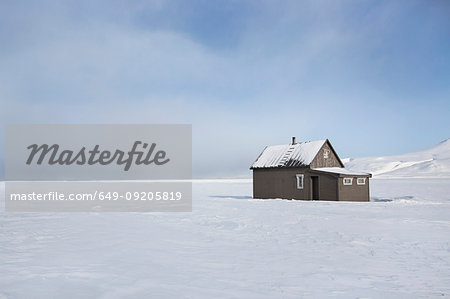 House in snow-covered field