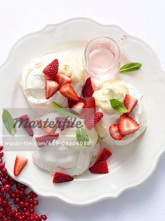 Plate of meringues with fruit and cream Plate of meringues with fruit and cream