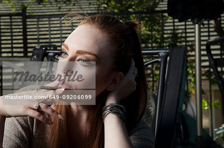 Woman smoking cigarette in lawn chair