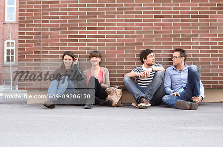 Friends relaxing on city street