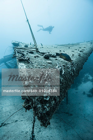 Diver examining underwater shipwreck