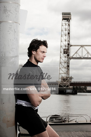 Runner standing on urban waterfront