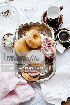 Tray of donuts with coffee and sugar