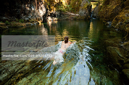 Woman swimming in river