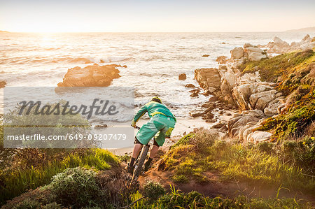 Mountain biker moving down coastal path, Monterey Bay area, California, USA