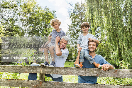 Portrait of three generation family males in garden