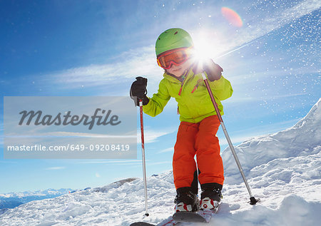 Young boy skiing downhill, low angle view