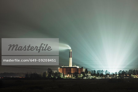 View of power station and smoke stack at night, Bremerhaven, Germany