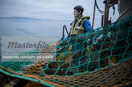 Fisherman preparing net, Isle of Skye, Scotland