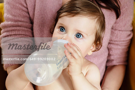 Baby boy drinking milk from bottle