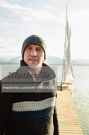 Mature man standing by jetty