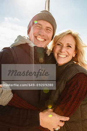 Portrait of mature couple outdoors, hugging, smiling