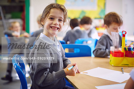 Portrait of girl at desk in elementary school