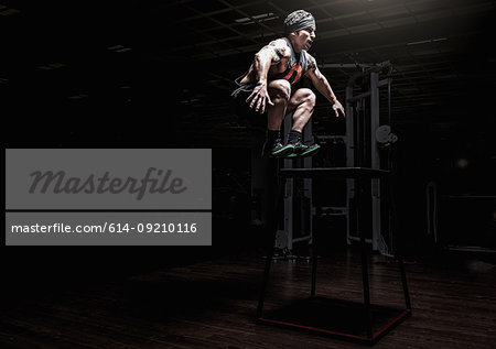 Young man leaping in gym