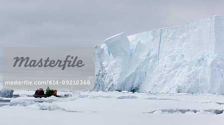 Boat approaching iceberg, ice floe in the southern ocean, 180 miles north of East Antarctica, Antarctica